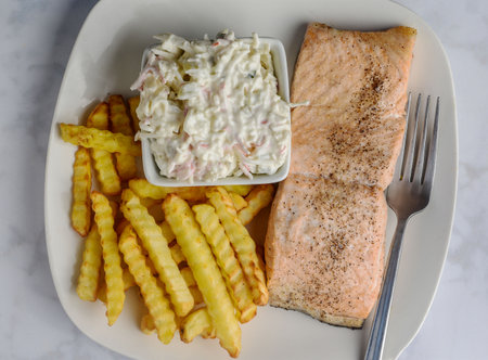 season baked salmon  served with french fries and seafood saladの写真素材