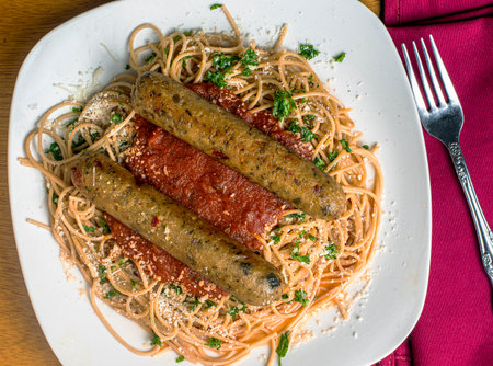 plant base  sausage on whole wheat spaghetti with parmesan cheese and parsley,の写真素材