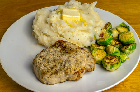 boneles pork chop served with roasted brussekl sprouts and mashed potatoesの写真素材