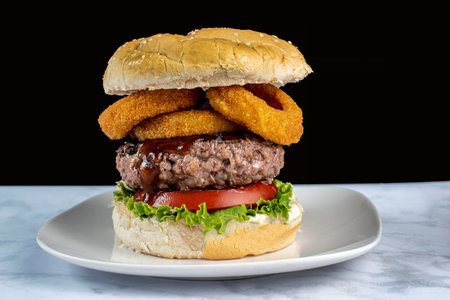 hamburger   served with barbecue sauce  and onin rings,の写真素材