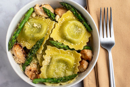 spinach and ricotta ravioli served with asparagus  and chicken top with parmesan cheese.の写真素材