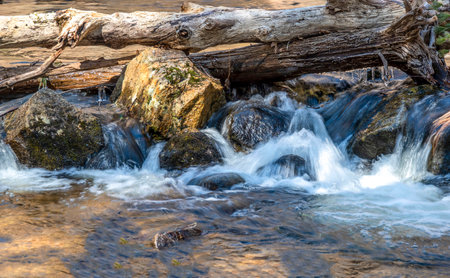water cascading over rocks in willard brook state forest in ashbyの写真素材