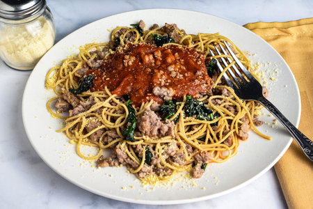 whole wheat spaghetti  top with  crumble sausage  and sauceの写真素材