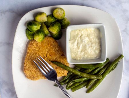plant based fish fillet served with green beans and brussel  sproutsの写真素材