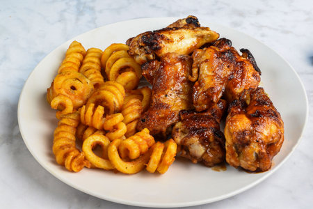 honey  barbecue wings served with  season curly fries,の写真素材