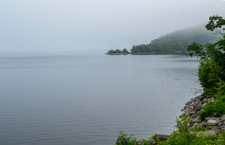 fog  covers the water and landscape of the quabbin reservoir