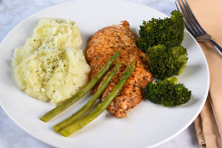 bake cod season with pepper salt  and paprika served with asparagus and mashed potatoes,の写真素材