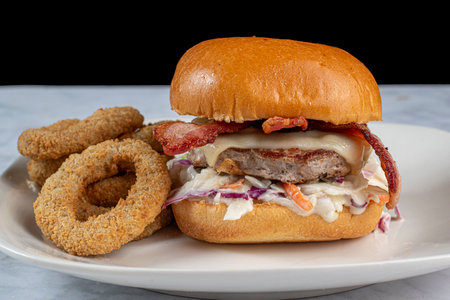turkey burger on cole slaw  served with melted swiss cheese and bacon,の写真素材
