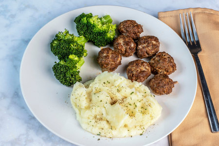 meat balls served  with broccoli and mashed potatoes