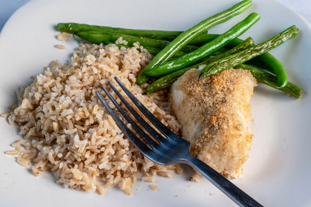 baked haddoc  served with  sauteed green beans and brown rice,の写真素材