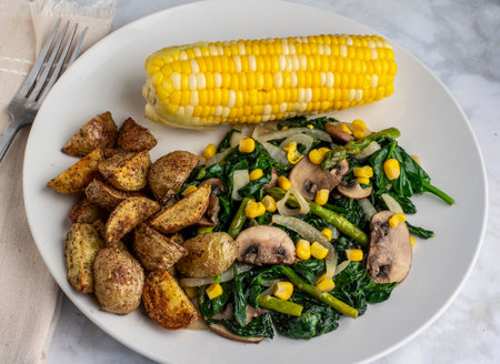 sauteed vegetables served with  corn  and home friesの写真素材