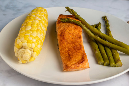 season salmon fillet  served with  asparagus and cornの写真素材