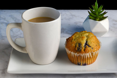 blue berry muffin with a cup coffeeの写真素材