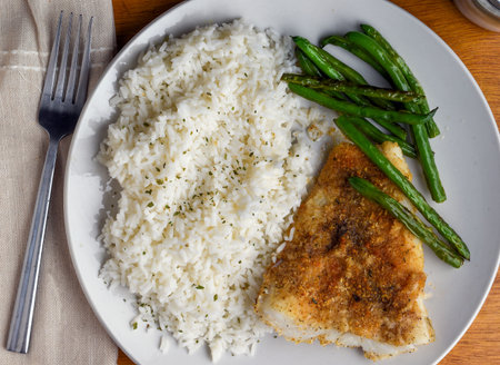 baked cod with  rice top with parsley  served with green beans