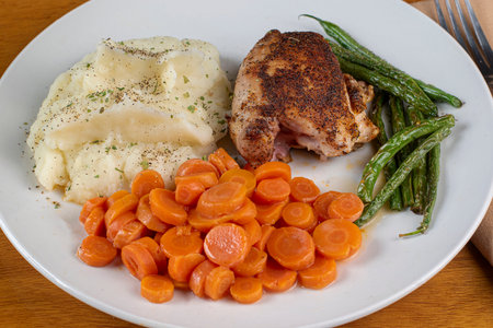 chicken thighs  served with carrots  green beans and mashed potatoes,の写真素材
