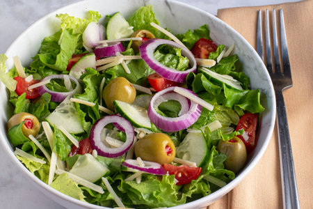 chopped salad served wit olive cheese and onionsの写真素材