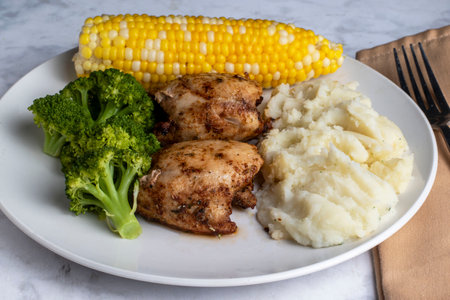chicken thighs served with broccoli and mashed potatoesの写真素材