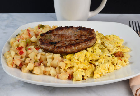 scramble eggs  and hsh browns served with sausage pattyの写真素材
