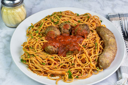 spaghetti top with pasrley  served with  meat balls and  sauceの写真素材