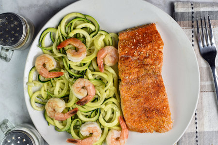 seasoned salmon served with zucchini noodles top with shrimpの写真素材