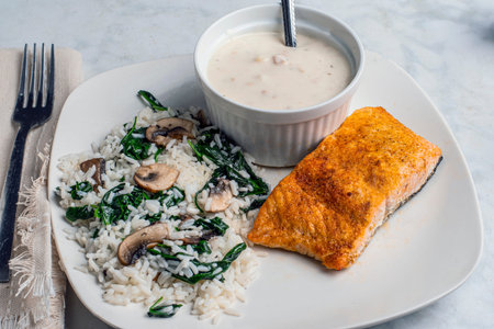 seasoned served with rice, sauteed spinach and mushrooms  and clam chowder.の写真素材