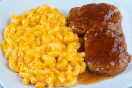 salisbury  steak top with gravy served with macaroni and cheese,の写真素材