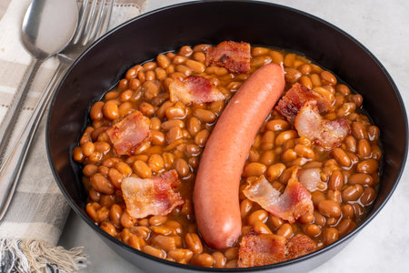 bacon with a hot dog  served on baked beansの写真素材
