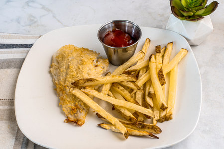 baked seasoned haddock served with french fries