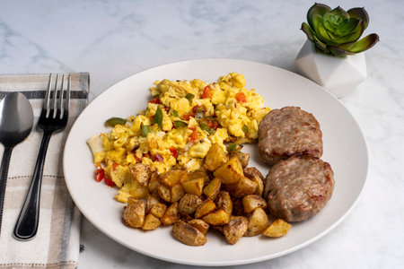 scramble eggs  with onions and peppers served with sausage pattiesand home fries