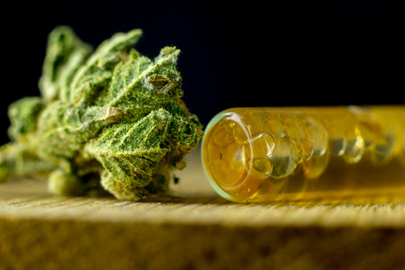 Medical Cannabis - marijuana flower and marijuana oil on the natural freshoak wood background.の写真素材