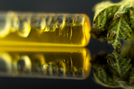 Medical Oil Cannabis - marijuana flower and oil cannabis on the mirror black background.の写真素材