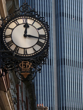 Old and New - an old 19c clock face against a modern tower block - this one in London