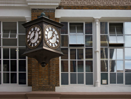 old two faced clock on an old buildingの写真素材