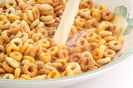 Bowl of breakfast cereal with fresh milk being poured
