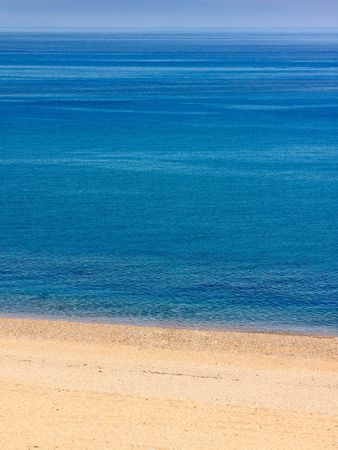 Deserted beach with brilliant blue sea background.の写真素材