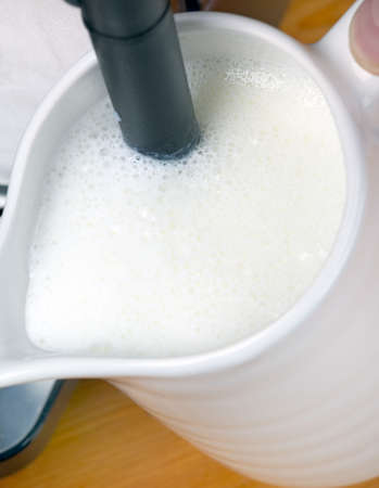 Frothing hot milk for coffeeの写真素材