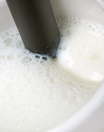 Making frothy milk for cappuccinoの写真素材