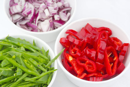 Fresh vegetables!  Diced peppers, onion and mange toutの写真素材