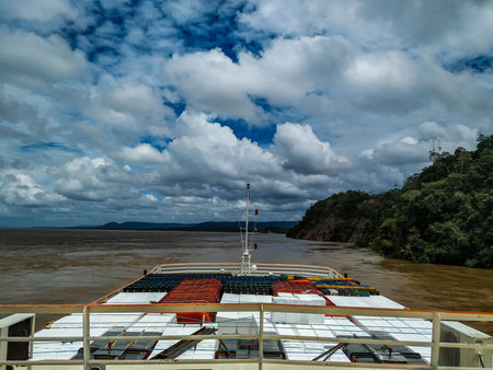 Cargo ship sailing the Amazon River. The photo shows the color of the waters and the forest on the...
