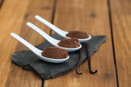 Chocolate mousse in ceramic white spoons on stone slateの写真素材