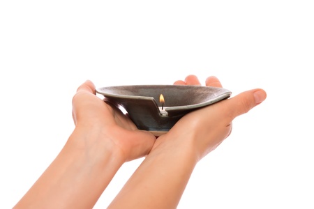 Candle in the hands isolated on white backgroundの写真素材