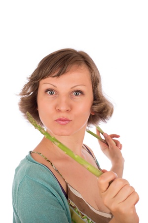 Portrait of naughty woman holding fresh green asparagus. Isolated on white background.の写真素材