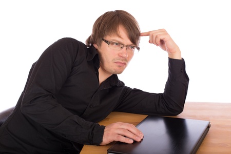 Business man sitting at a table and think seriously about a business idea. Isolated on white background.の写真素材