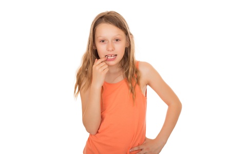 Young girl with long hairs lost a tooth. Isolated on white background.の写真素材