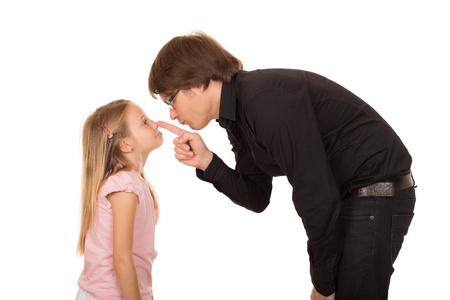 Despairing father pointing the finger and explains what's wrong to her little daughterの写真素材