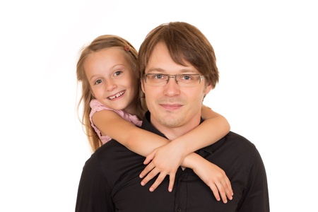 Father giving piggyback ride to his daughter. Isolated on white background.の写真素材
