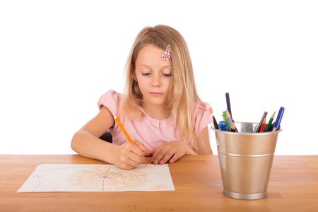 Child draw a pretty picture on a wooden table. Isolated on a white background.の写真素材