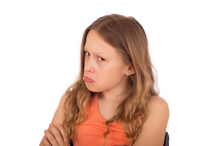 Angry child make a grimace. Isolated on a white background.の写真素材