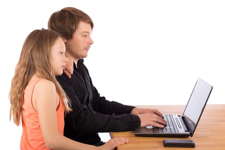 Father working with his daughter on a laptop. Isolated on a white background.の写真素材