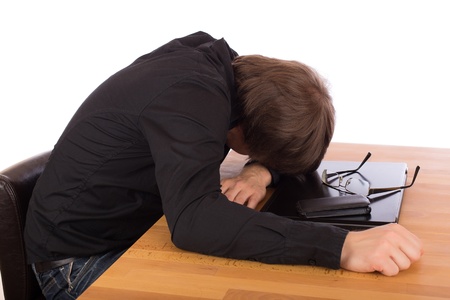 Business man sleep on his laptop. Isolated on a white background.の写真素材